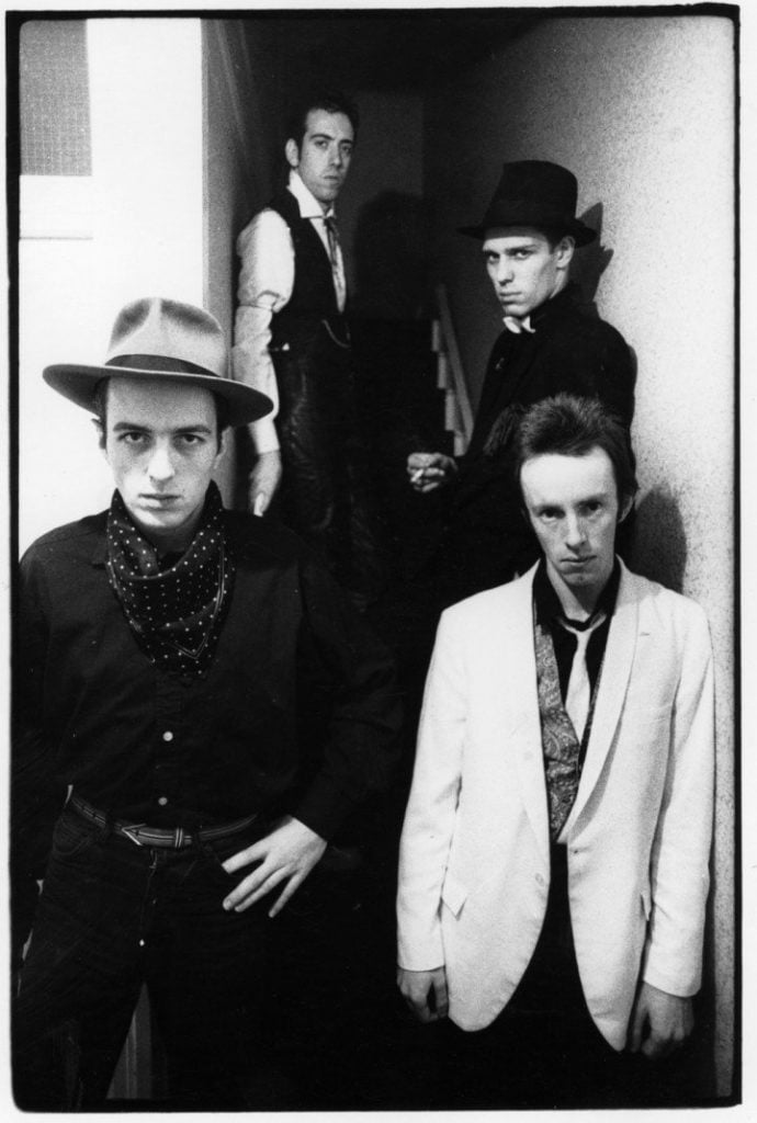 The Clash in a publicity shot for London Calling 1979. Photography by Pennie Smith which shows off their visual asthetic of vintage wide brim hats, suits and ties and waistcoats.