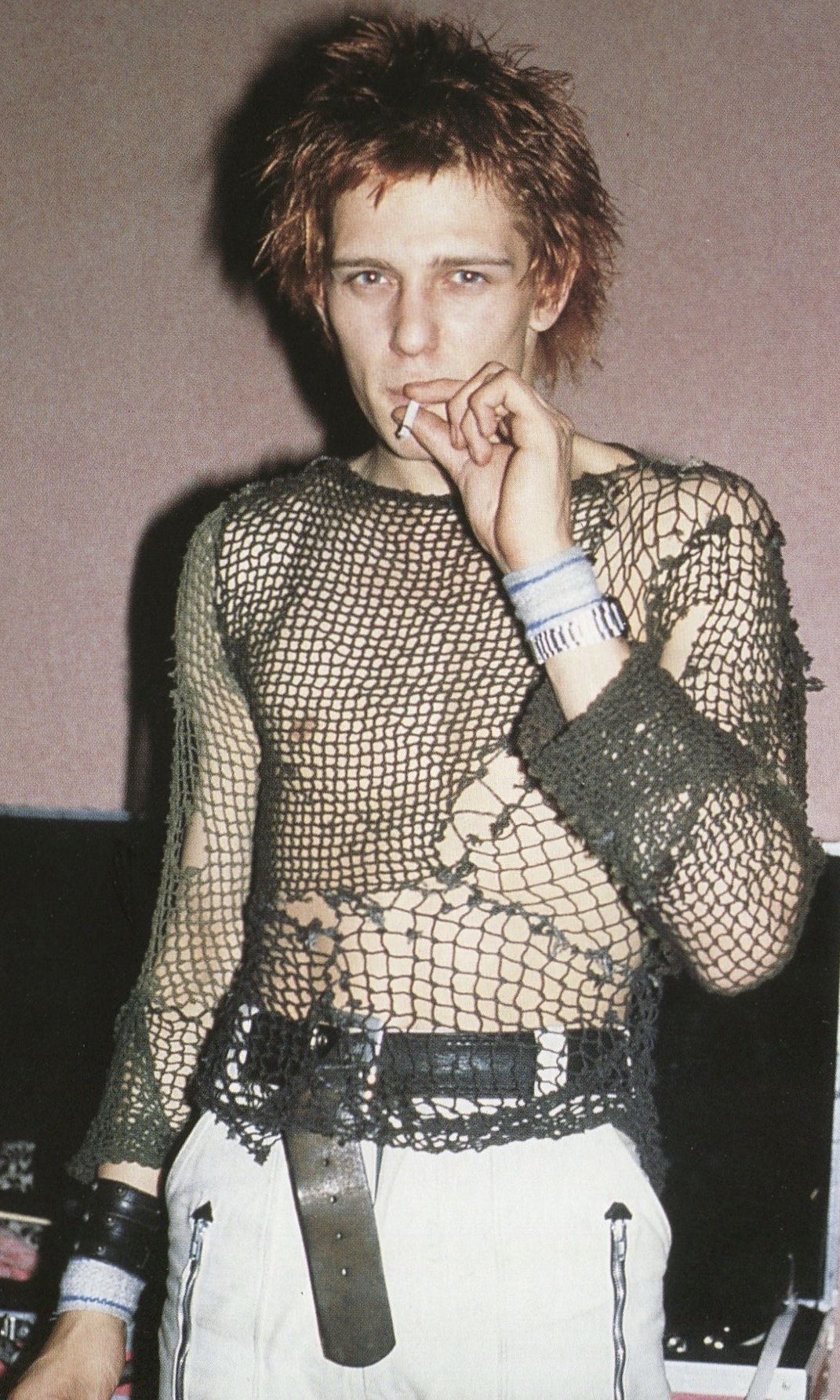 This photograph shows Paul in a knit sweater he made himself that resembles an open fishnet DIY style black and white outfit 