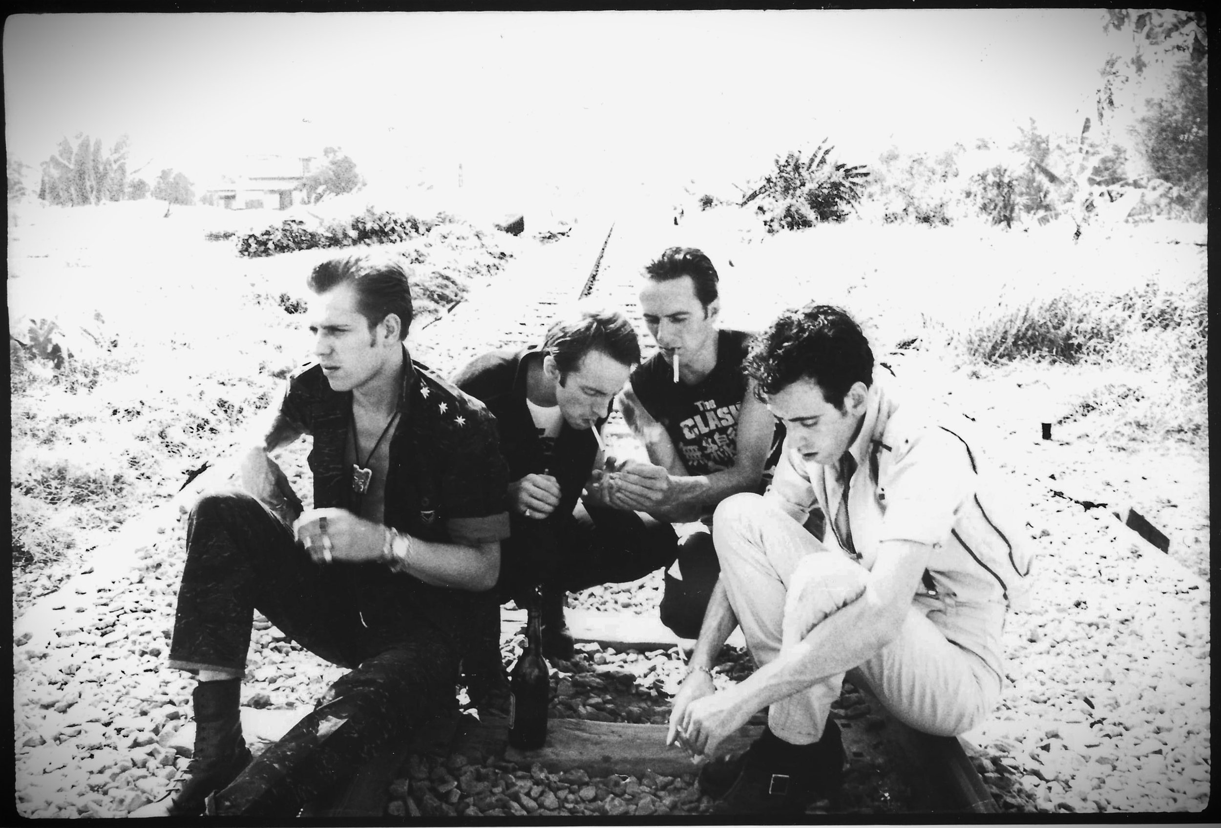 A black and white photograph by Pennie Smith of members Joe Strummer & Topper Headon sleeping backstage.