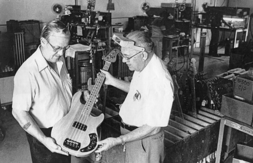 black and white picture of george fullerton and leo fender with a g and l guitar