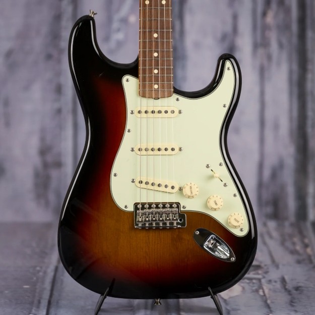 Picture of the lower end of sunburst fender guitar