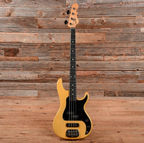 Natural wood bass guitar with black pickguard