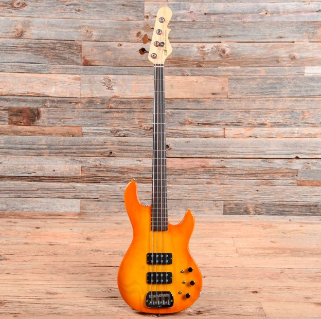 Bright orange and yellow sunburst bass guitar with black hardware