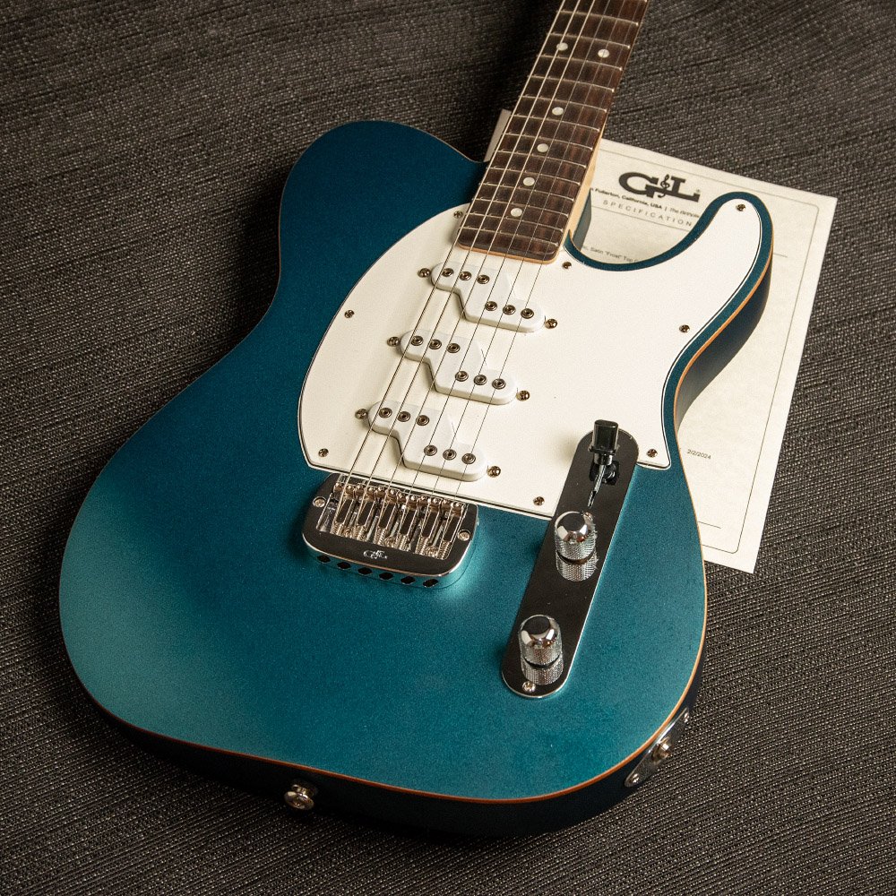 Hero image of a Blue G and L guitar resting against shelving in Leo Fender's work area