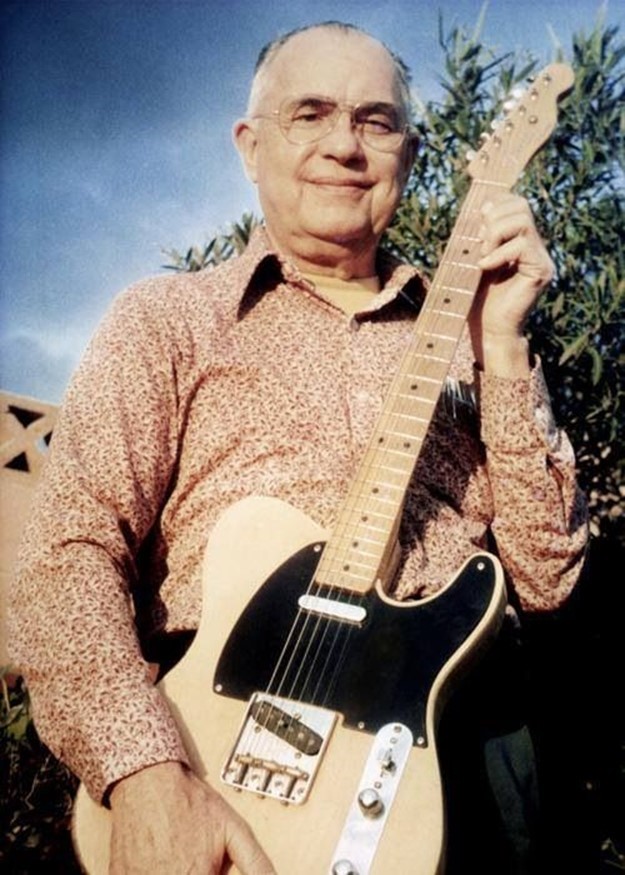 Leo Fender in holding a telecaster guitar