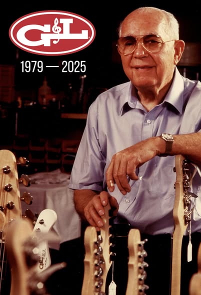 Leo Fender standing in front of a group of guitars with his elbow resting on a headstock