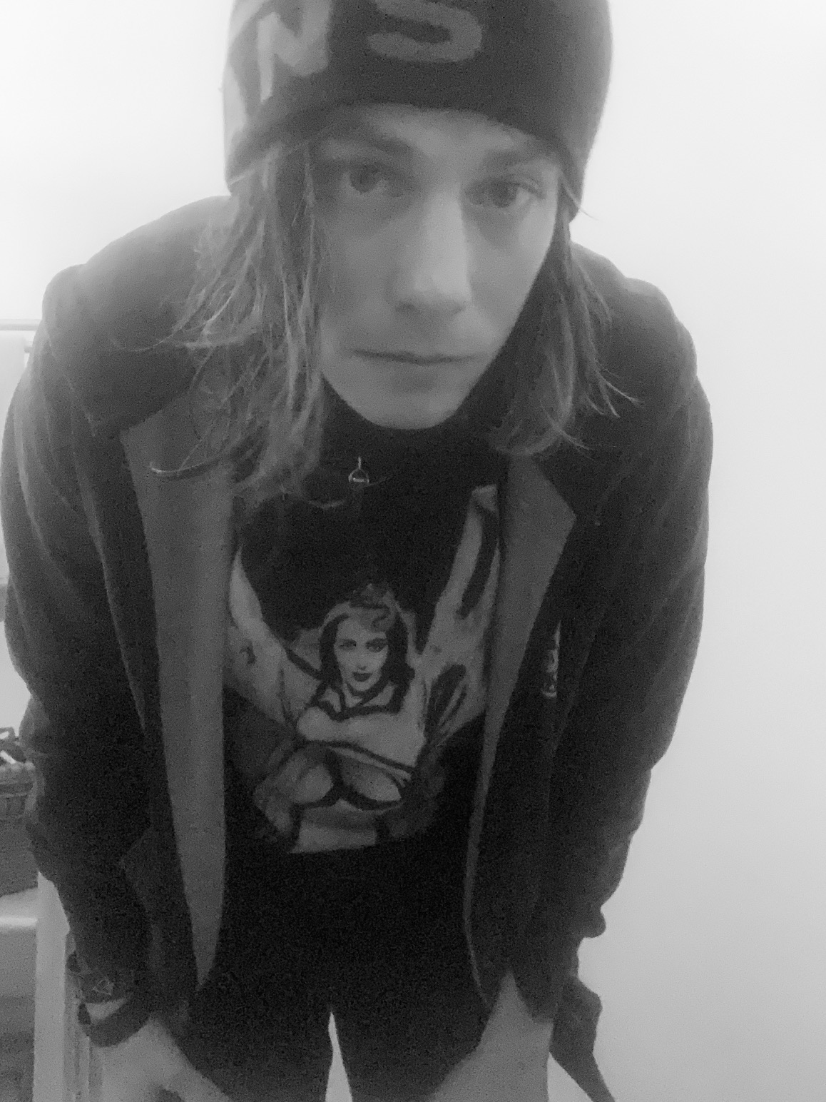 Black and white selfie of author/editor dressed in hoodie and beanie
