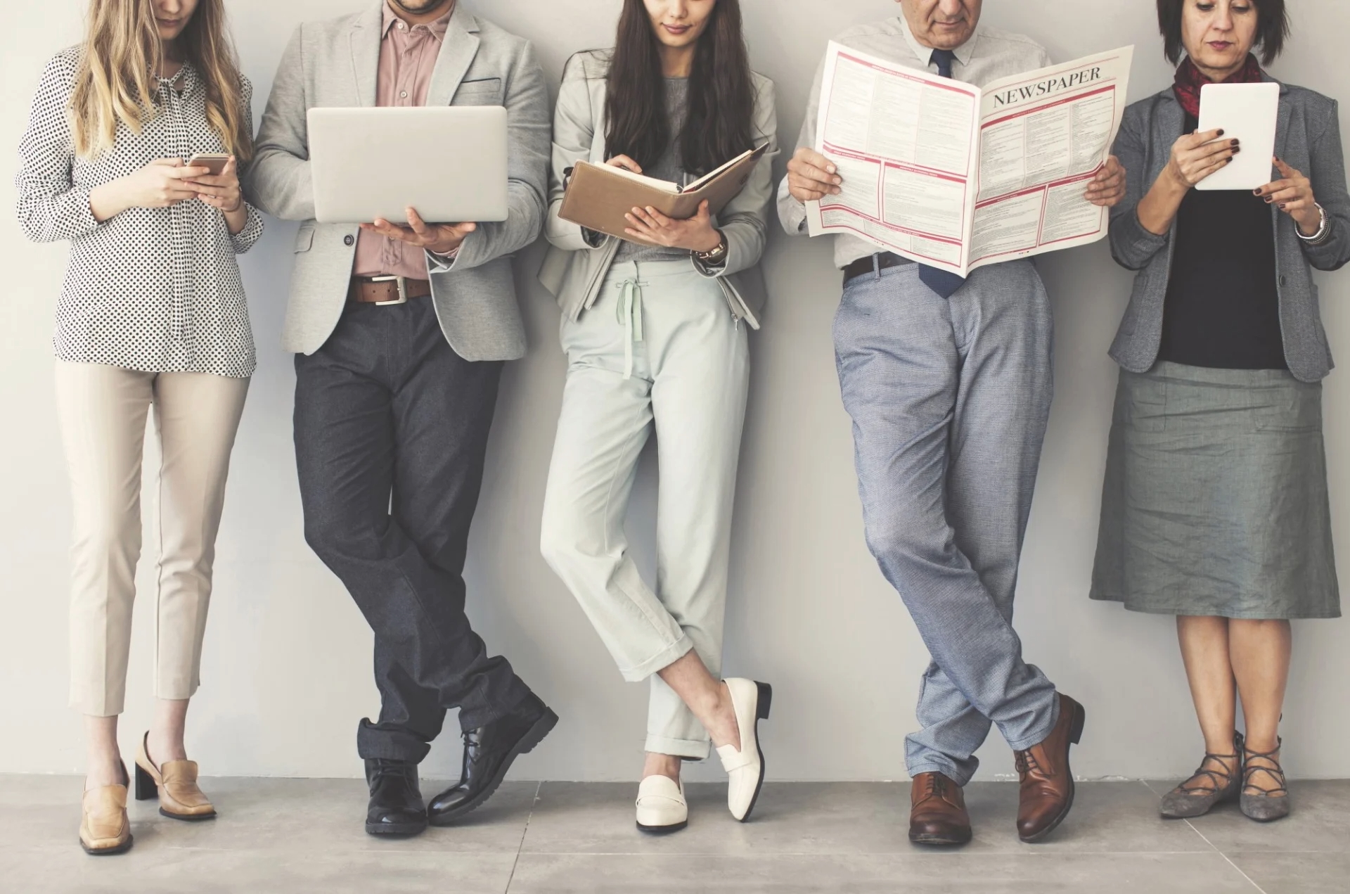 photo of diverse people using technology and reading texts