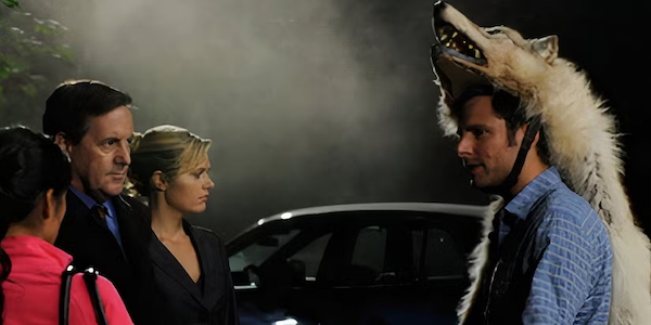 photo of shawn, juliet, and other characters in season 4, epsiode 8. Shawn is wearing a wolf head