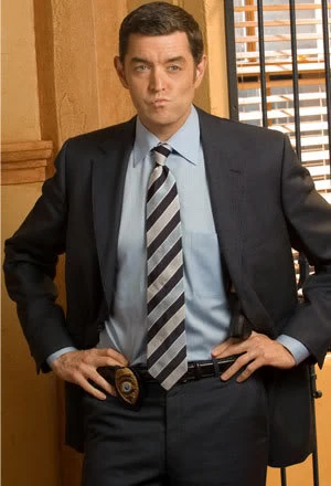 photo of Carlton Lassiter with a smirk on his face in Psych