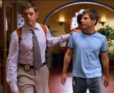 photo of Carlton Lassiter with his hand on Shawn Spencer's shoulder, walking in the police station, in Psych