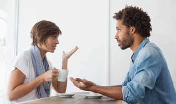 an image of two people having a conversation over coffee