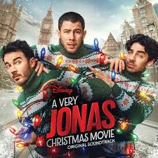 Festive cover featuring three men in matching green Christmas sweaters wrapped in colorful string lights, with snowy city buildings and the title text that reads, A Very Jonas Christmas Movie.