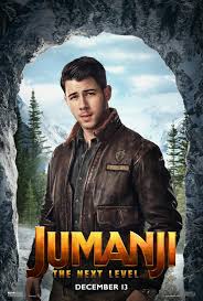 Adventure movie poster showing a man in a brown leather jacket standing in a rocky mountain landscape, framed by a cave opening, with the large title “Jumanji: The Next Level.”