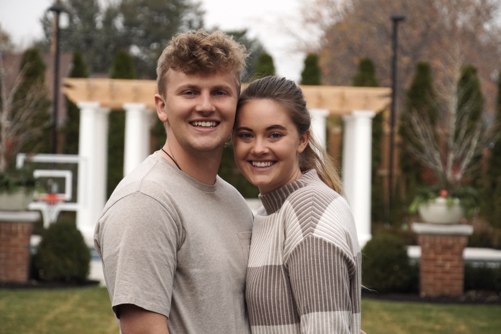 a blonde couple smiling for the camera