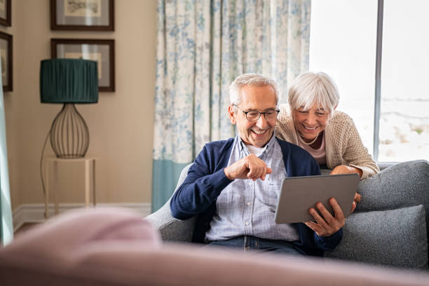 two grandparents presumably facetiming somebody on an ipad