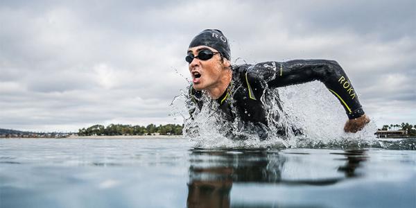 a person diving up for air as they swim in the ocean