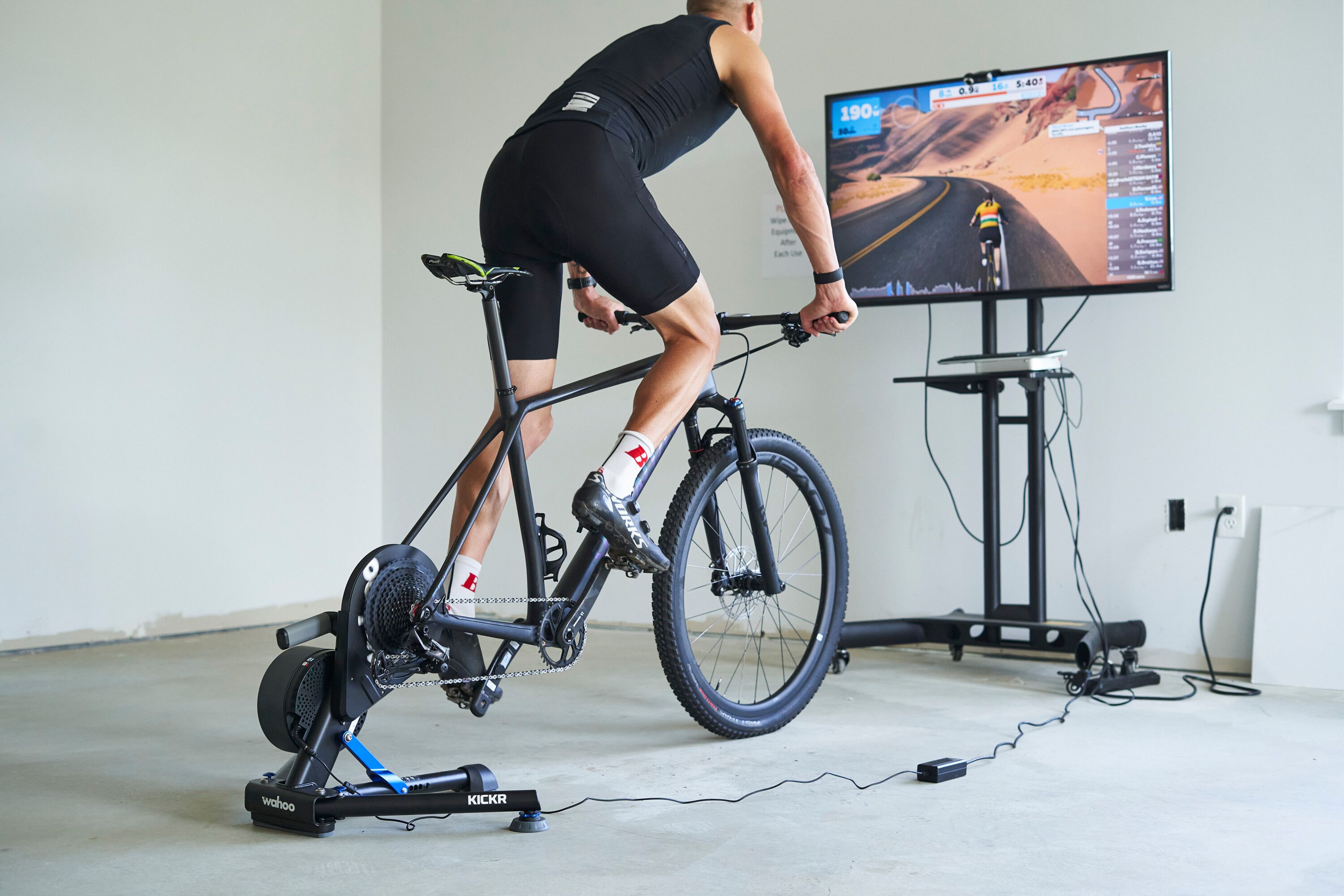 a man at home that hooked up his bike to a trainer as he does an at home workout