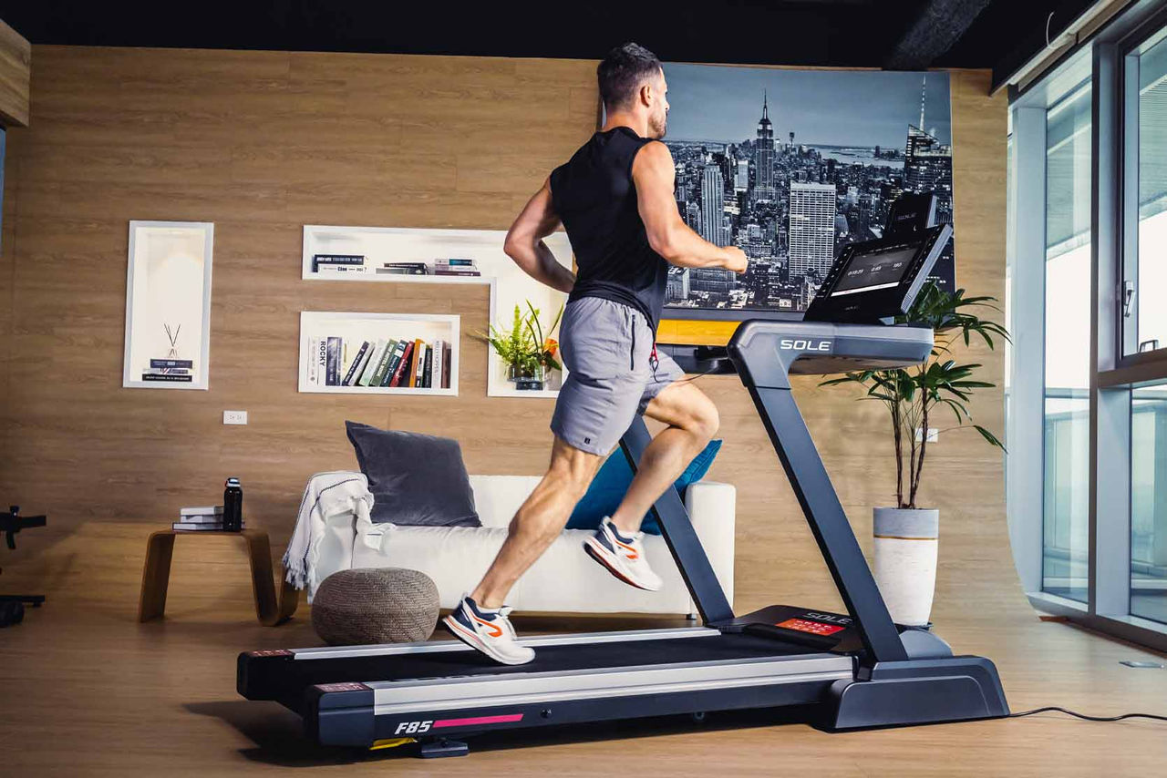 a man running on a treadmill in his home