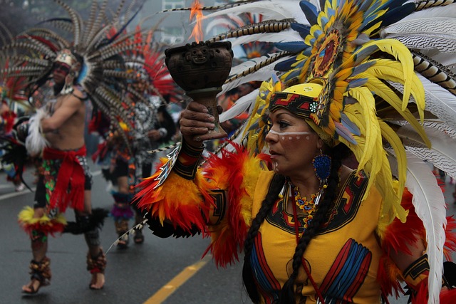 native americans in traditional clothing walking down an asphalt road