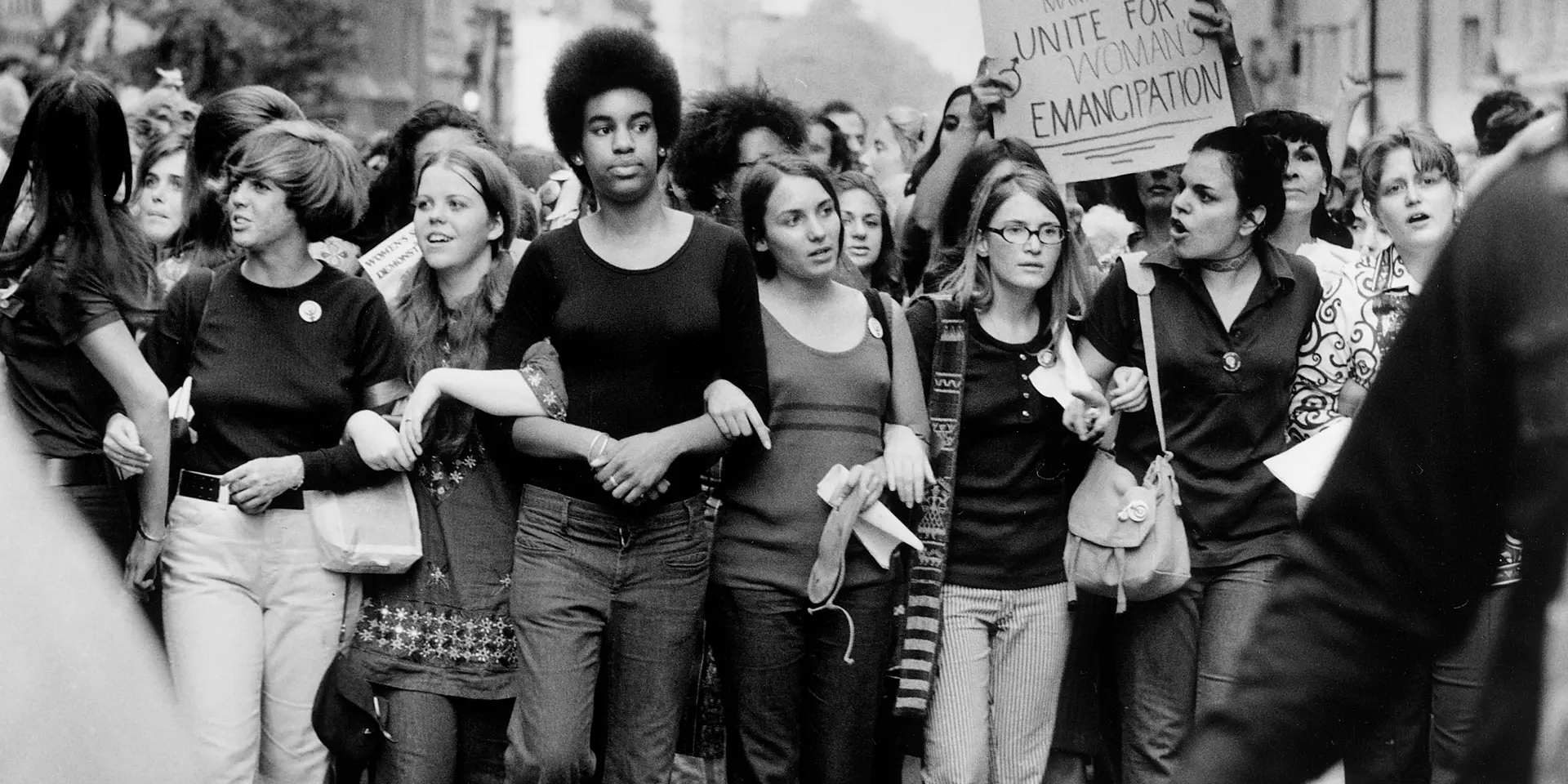 John Olson's greyscale photograph of women joined at the arms at 1970 protest in NYC