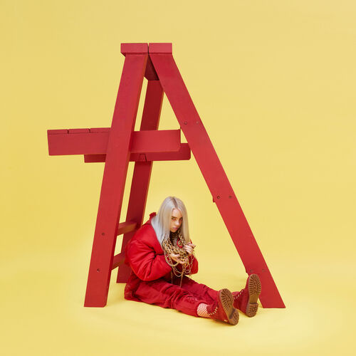 A picture of Billie Eilish sitting in front of a red ladder. She's wearing all red and the background is yellow