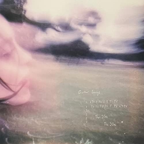 A faded image of Billie Eilish's side profile, with her hair blowing in the wind. An empty grass field next to her and clouds in the sky, all a bit blurry