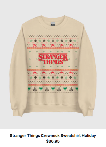 An cream-colored sweatshirt with the red Stranger Things logo on it, surrounded by green and red holiday designs. Words beneath it say Stranger Things Crewneck Sweatshirt Holiday $36.95