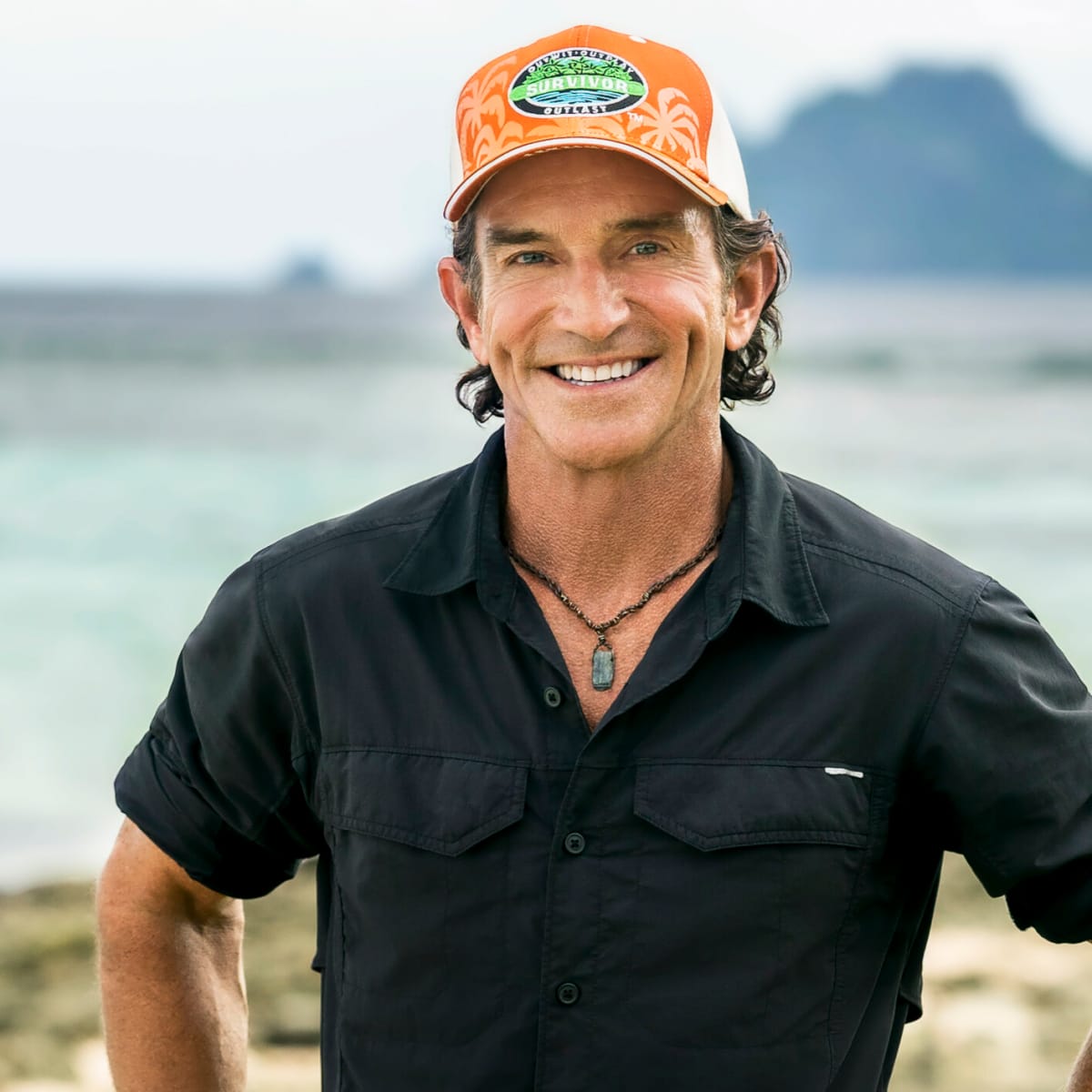 Jeff Probst smiling in an orange hat.