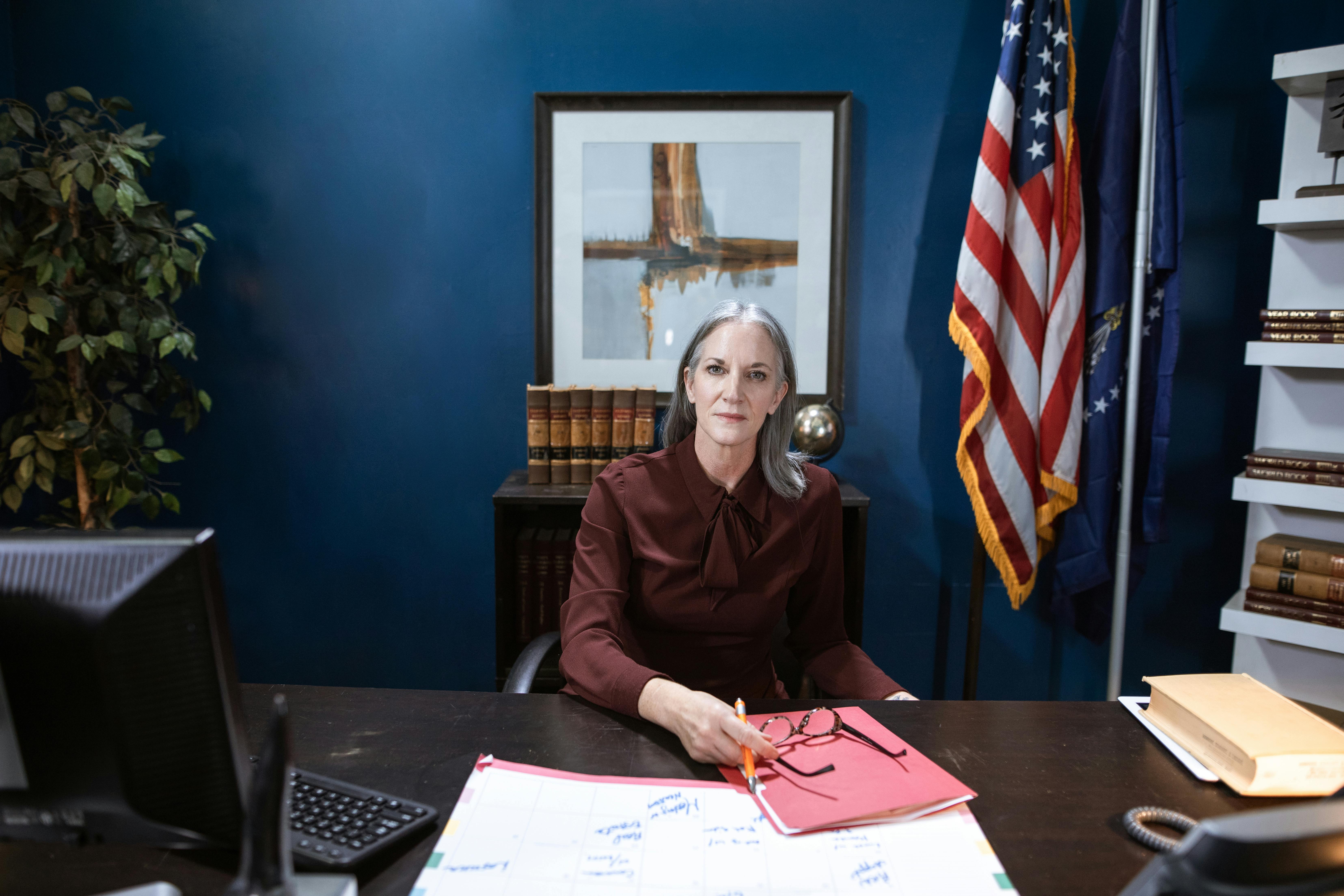 Professional Woman sitting beside a Wooden Table