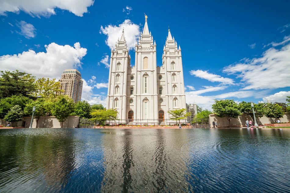 The Salt Lake City Temple of the Church of Jesus Christ of Latter-Day Saints facing a fountain during the daytime