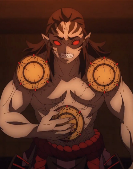 A tall, muscular, humanoid demon with sharp markings on his forehead, black hair, razor sharp teeth, pointy ears, and blood red sclera. His stomach, shoulders, hips, front chest and back all have drums protruding from them. 