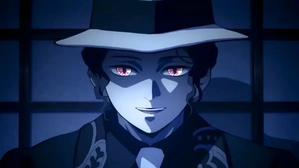 Muzan in his dark green suit and white and green hat looking forward. He is in a blue-hued room which brings out the red of his demon eyes.