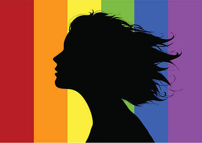 silohuette of a women in front of a pride flag