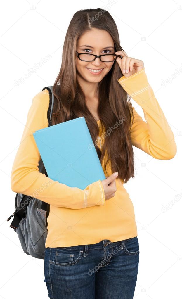 a stock image of a young woman with glasses and a text book dressed in early 2000's fashion.