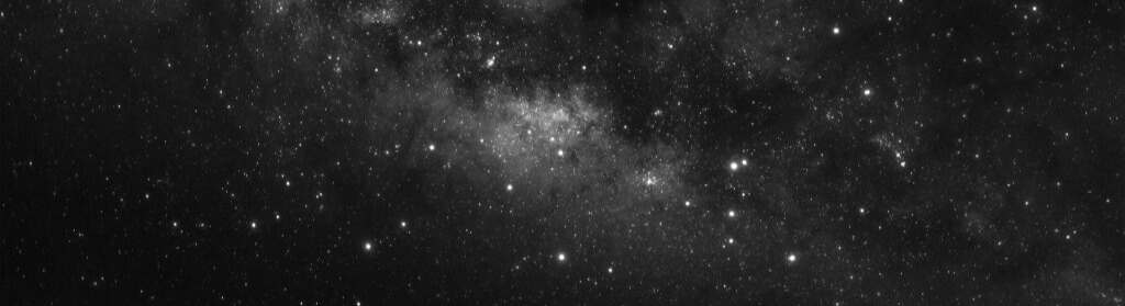 a black and white photograph of galaxies and stars in outer space