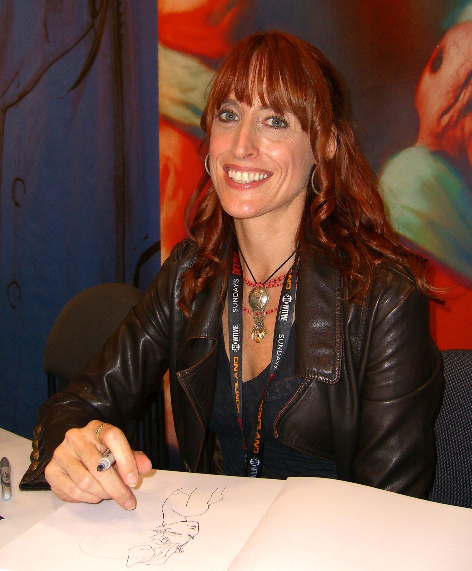 A photo of Magali Villeneuve over one of her illustrations