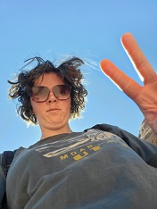 the essay's editor, a young woman wearing a 'Utah' t-shirt and sunglasses