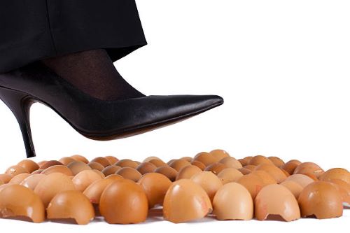 black high heel stepping on eggshells