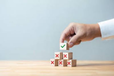 a stack of blocks forming a pyramid, all blocks have a red x except for the top block, which has a green checkmark