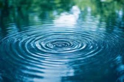 image of one drop of water in a puddle of water sending out ripples