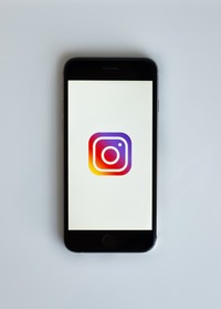 an Iphone on a blank background with only the instagram logo centered on the screen