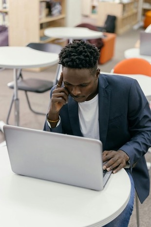 Man researching on laptop