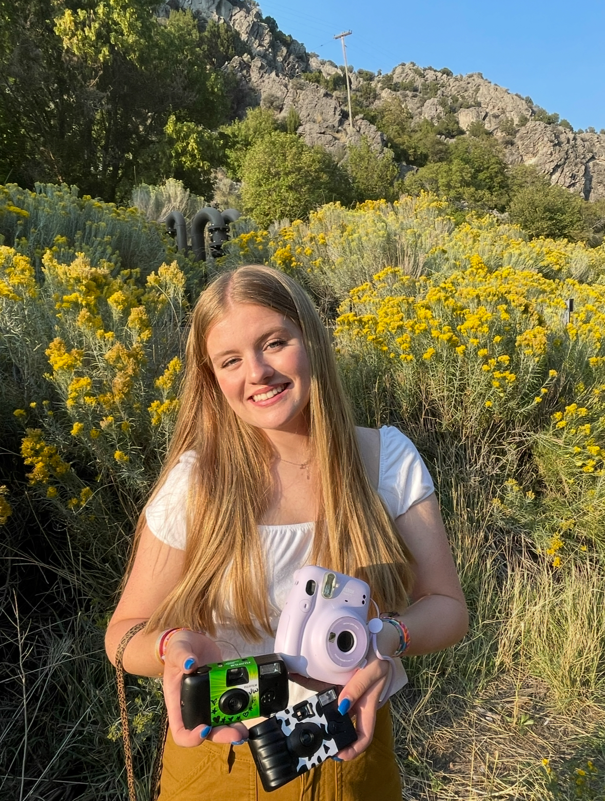 Jacey Wilson holding two cameras.