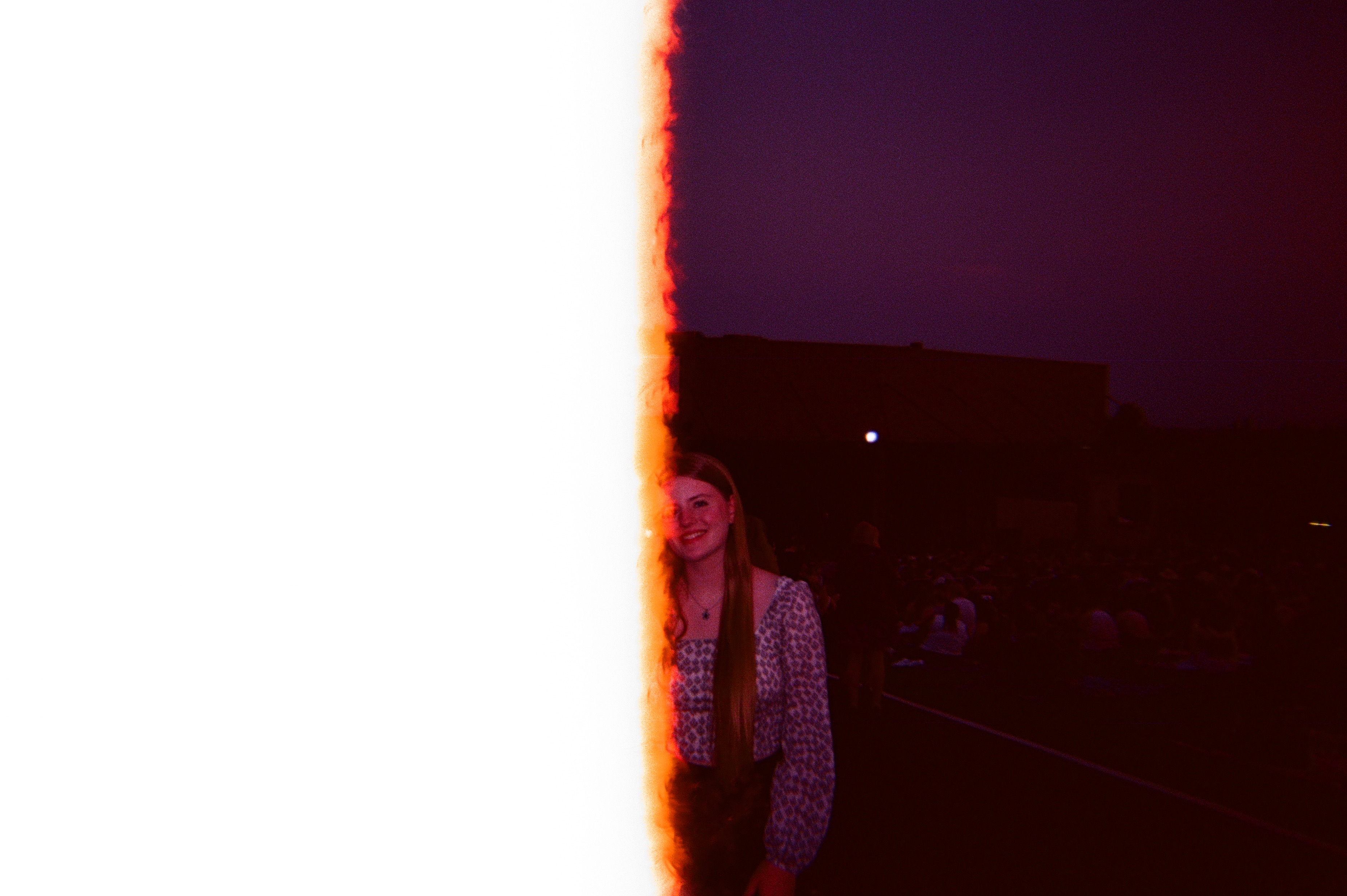 Light leak covering entire left side of the photo, hiding one of the two people featured.