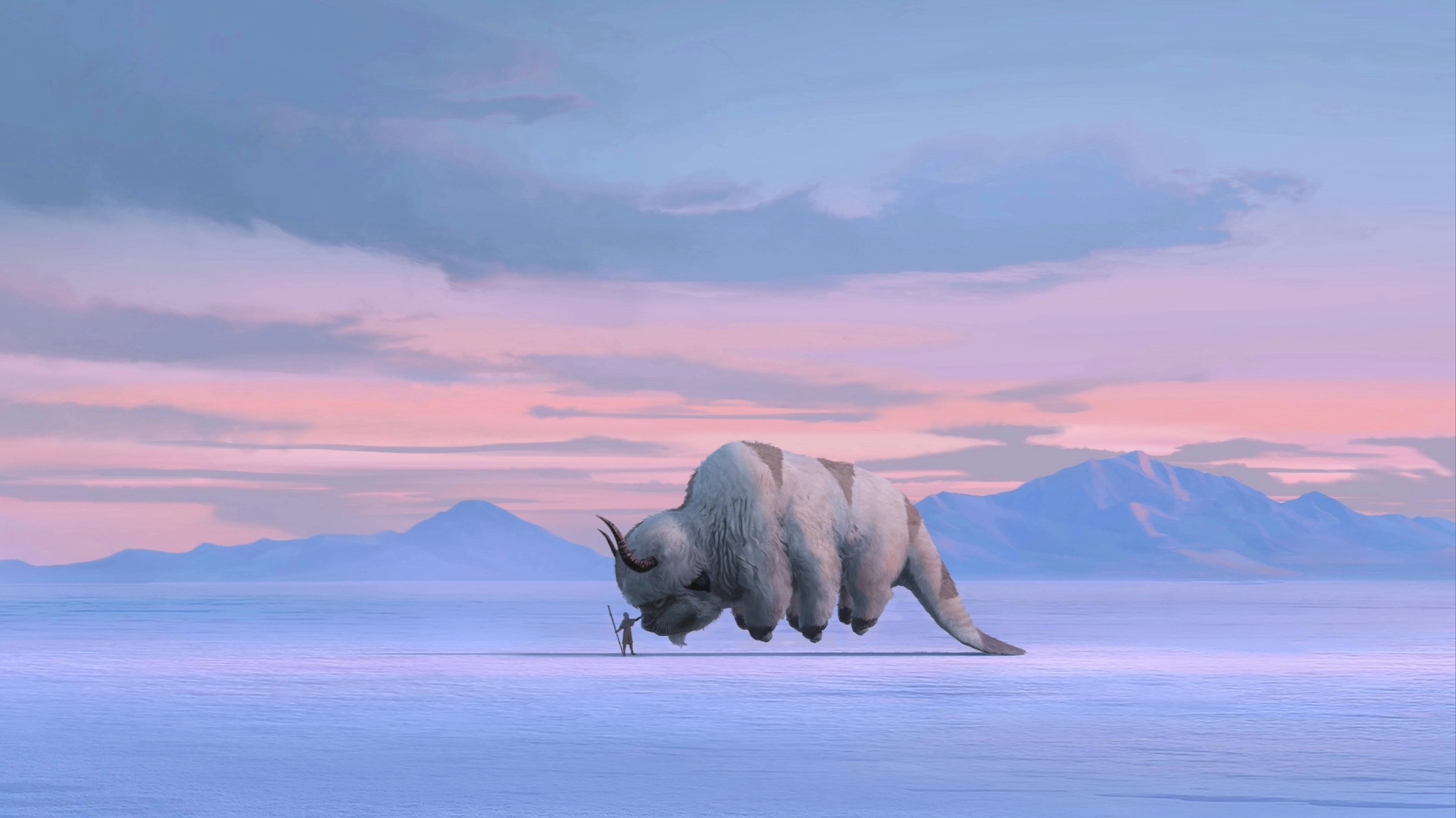 a watercolor-esque image of Aang petting his skybison Appa; the pair are set against a mountainrange during what looks to be a sunrise of pale blues and pinks
