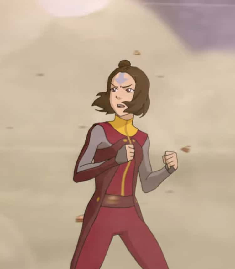 Jinora, a young woman with an airbending tattoo peeking out from her hair; she wears a maroon and yellow jumpsuit designed for air travel