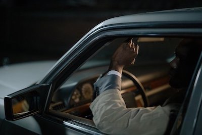 man's arm sticking out of a rolled down driver's window