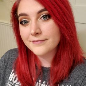 a photo of Brittany Olson, slightly smiling, her bright red hair falling to her shoulders