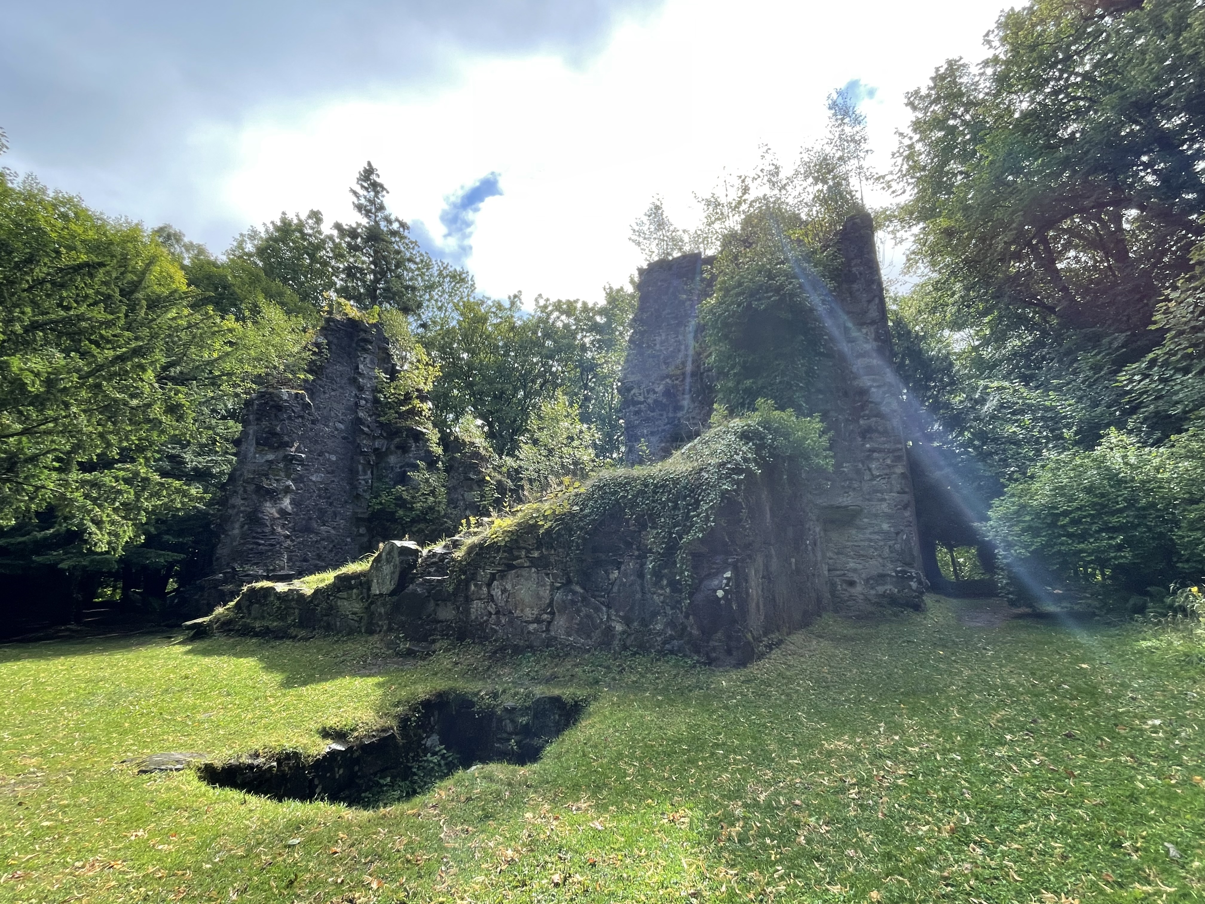 the mossy ruins of s stone castle amidst a green landscape